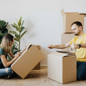 Couple packing to move home